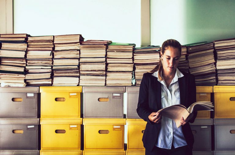 Woman Purge File Clutter in Office