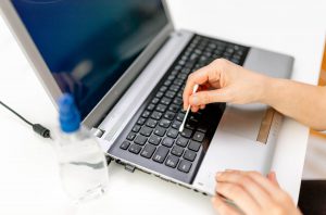 Clean Computer Keyboard with Cotton Swap