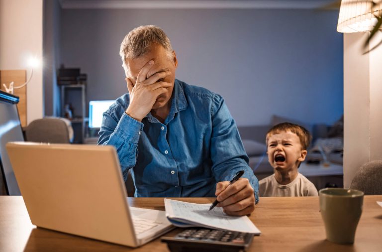 Stressed Employee with Son Working Home