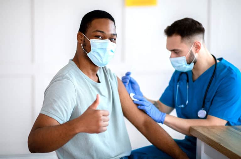 Man with Mask Giving Thumbs Up Coronavirus Vaccination