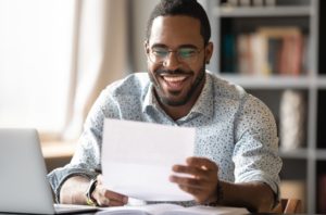 Cheerful Employee with Scholarship Letter