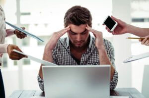 Businessman Stressed at Office Desk