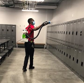 Janitor Disinfecting Locker Room