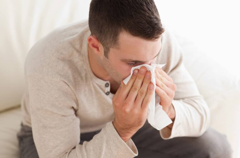 Man with Flu Blowing Nose