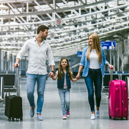 Happy Family Walking in Airport Terminal
