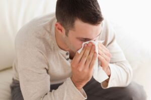 Sick Employee Blowing His Nose