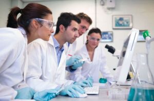 Researchers Watching Computer in Laboratory