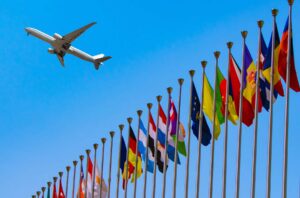 Plane Flying Over Global Flags