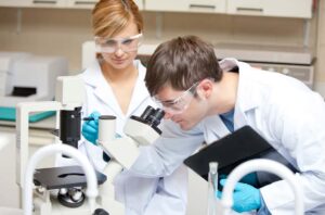Scientists Observing Microscope Laboratory