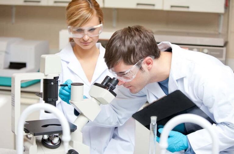 Scientists Observing Microscope Laboratory