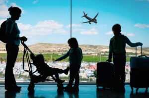 Mother and Kids with Luggage at Airport