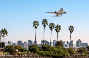 Plane Flying Above San Diego Skyline