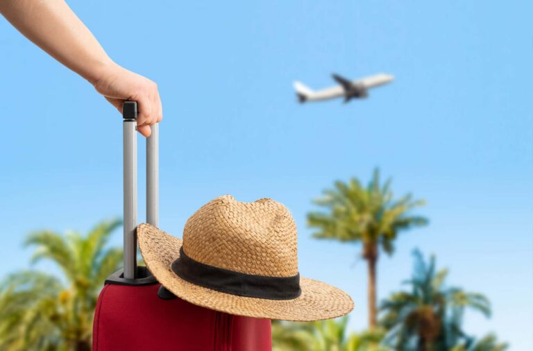 Vacation Suitcase with Airplane in Background