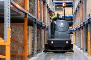 Janitor on Ride-On Floor Sweeper